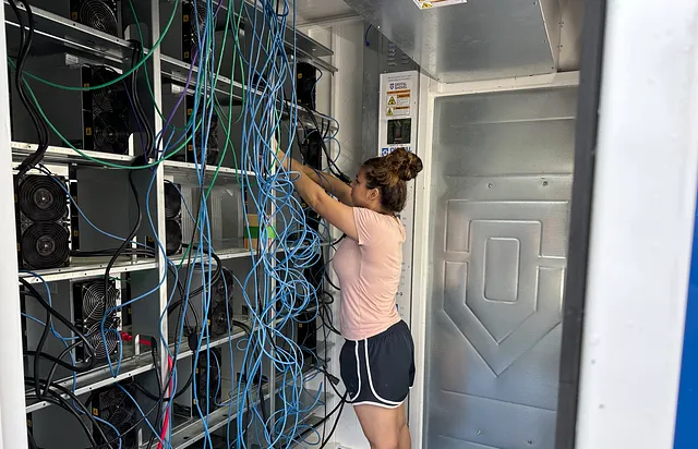 Miss Vosk Alexa deploying mining rigs on the VoskCoin mining farm in the pod